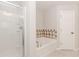 Bright bathroom featuring a soaking tub, glass shower, and ceramic tile at 507 Grove Field Ct, Suwanee, GA 30024