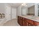 Bathroom features double sink vanity with granite countertops, large mirror and ceramic tile at 507 Grove Field Ct, Suwanee, GA 30024