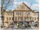 Attractive townhome featuring a symmetrical facade, covered porch, and manicured landscaping at 507 Grove Field Ct, Suwanee, GA 30024