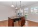 Kitchen island features granite countertops, stainless steel appliances and provides extra storage at 507 Grove Field Ct, Suwanee, GA 30024