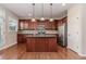 Well-equipped kitchen features stainless appliances, central island and ample cabinet space at 507 Grove Field Ct, Suwanee, GA 30024