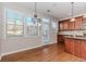 Bright kitchen and breakfast nook features hardwood floors, stainless steel appliances and lots of natural light at 507 Grove Field Ct, Suwanee, GA 30024