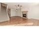 Spacious living room showcases hardwood floors, a stone fireplace, and a staircase to the upper level at 507 Grove Field Ct, Suwanee, GA 30024