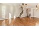 Open living room showcases hardwood floors, a staircase, and natural light streaming through the windows at 507 Grove Field Ct, Suwanee, GA 30024