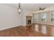 Sunlit living room with hardwood floors, stone fireplace, and large windows overlooking the backyard at 507 Grove Field Ct, Suwanee, GA 30024
