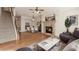 Inviting living room features a stone fireplace, hardwood floors and a staircase to the upper level at 507 Grove Field Ct, Suwanee, GA 30024