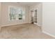 Sunlit office space with large windows, neutral carpet, and glass french doors at 507 Grove Field Ct, Suwanee, GA 30024