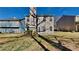 Home's backyard features a patio and mature trees at 6599 Coventry Pt, Austell, GA 30168