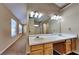 Bright bathroom featuring double sinks, a large mirror, and a well-lit vanity area at 6599 Coventry Pt, Austell, GA 30168