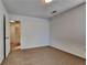 Bedroom with neutral walls, plush carpeting, ceiling light, and doorway to another room at 6599 Coventry Pt, Austell, GA 30168