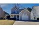 Charming two-story home with a gray exterior, attached garage, and well-maintained front lawn at 6599 Coventry Pt, Austell, GA 30168