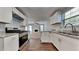 Beautifully updated kitchen with stainless steel appliances and white cabinets offering great storage at 6599 Coventry Pt, Austell, GA 30168