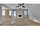 Spacious living room with carpet, a cozy fireplace, and natural light from the windows at 6599 Coventry Pt, Austell, GA 30168