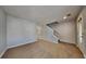 Inviting living area with neutral walls, carpeted floors, and a staircase, perfect for gatherings at 6599 Coventry Pt, Austell, GA 30168