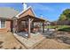 Large backyard with covered patio and outdoor seating area, complemented by lush landscaping at 1993 Shenley Park Ln, Duluth, GA 30097