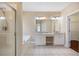 This bright bathroom features a soaking tub, glass shower, granite countertops, and double sinks at 1993 Shenley Park Ln, Duluth, GA 30097