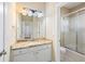 Bright bathroom featuring a granite countertop and a shower with sliding glass doors at 1993 Shenley Park Ln, Duluth, GA 30097