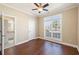 Cozy bedroom with hardwood floors, a ceiling fan and a bright window at 1993 Shenley Park Ln, Duluth, GA 30097