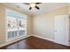 Well-lit bedroom with dark wood floors and a large window overlooking the neighborhood at 1993 Shenley Park Ln, Duluth, GA 30097