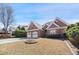 Traditional brick home featuring a two-car garage and a neat front lawn at 1993 Shenley Park Ln, Duluth, GA 30097