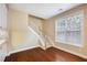 Hallway with hardwood floors, white trim, staircase and natural light at 1993 Shenley Park Ln, Duluth, GA 30097