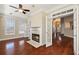 Spacious living room boasting hardwood floors, fireplace, ceiling fan, and views into the entry and dining area at 1993 Shenley Park Ln, Duluth, GA 30097