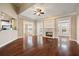 Spacious living room with hardwood floors, a fireplace, and an open concept layout into the kitchen at 1993 Shenley Park Ln, Duluth, GA 30097