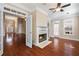 Living room with hardwood floors, a fireplace, and double doors leading into the foyer and other rooms at 1993 Shenley Park Ln, Duluth, GA 30097