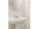 Clean pedestal sink with oval mirror in a bright, simple bathroom setting at 2236 Bigwood Trl, Atlanta, GA 30349