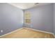Neutral bedroom features a window and wall-to-wall carpet at 2236 Bigwood Trl, Atlanta, GA 30349