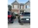View of home exterior featuring neutral siding, brick accents, and a well-maintained driveway at 2236 Bigwood Trl, Atlanta, GA 30349