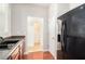 Well-lit kitchen featuring dark cabinetry, wood floors, and stainless steel refrigerator at 2236 Bigwood Trl, Atlanta, GA 30349