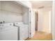 Laundry room featuring washer, dryer, and shelving with easy access at 2236 Bigwood Trl, Atlanta, GA 30349