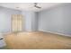 Spacious living room featuring neutral paint, ceiling fan, and sliding glass doors to the backyard at 2236 Bigwood Trl, Atlanta, GA 30349