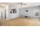 Spacious living room featuring neutral paint, ceiling fan, open access to the kitchen, and backyard views at 2236 Bigwood Trl, Atlanta, GA 30349