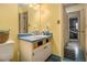Colorful bathroom with yellow walls and vanity, a blue countertop, and tiled flooring at 570 Knollwood Dr, Stockbridge, GA 30281