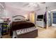 Comfortable carpeted bedroom featuring a ceiling fan, a double bed, and personal decor and fixtures at 570 Knollwood Dr, Stockbridge, GA 30281