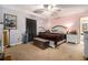 Cozy carpeted bedroom featuring a ceiling fan, a double bed, and personal decor and fixtures at 570 Knollwood Dr, Stockbridge, GA 30281