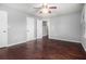 Bright bedroom with dark hardwood floors, a neutral gray paint scheme, and a ceiling fan at 570 Knollwood Dr, Stockbridge, GA 30281