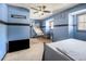 Carpeted bedroom featuring a bed with metal frame, window with wood blinds, and dark blue walls at 570 Knollwood Dr, Stockbridge, GA 30281