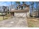 An angle of a charming single-Gathering home with attached garage and basketball hoop in the driveway at 570 Knollwood Dr, Stockbridge, GA 30281