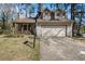 Cozy two-story home with a charming porch, two dormer windows, and attached garage with basketball hoop at 570 Knollwood Dr, Stockbridge, GA 30281