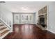 Inviting living room with hardwood floors, a stone fireplace, and ample natural light from large windows at 570 Knollwood Dr, Stockbridge, GA 30281