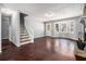 Bright living room with stone fireplace, staircase to the second floor, and hardwood floors at 570 Knollwood Dr, Stockbridge, GA 30281