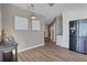 View of hallway with wood floors, decorative wall art, and view into the kitchen with stainless refrigerator at 855 Peachtree Ne St # 1703, Atlanta, GA 30308