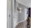 Hallway with two white paneled doors, light hardwood flooring, and a decorative wall sconce at 855 Peachtree Ne St # 1703, Atlanta, GA 30308