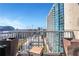 City skyline view from a balcony with patio furniture, featuring high-rise buildings and a vibrant urban landscape at 855 Peachtree Ne St # 1703, Atlanta, GA 30308