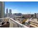 Balcony view of the city from a high-rise condo with a clear blue sky on a sunny day at 855 Peachtree Ne St # 1703, Atlanta, GA 30308