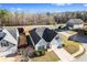 An aerial view of the home and neighborhood, featuring light gray siding, a dark roof, and a convenient attached garage at 165 Birch St, Hiram, GA 30141