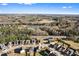 An aerial view of a residential community with a lake, trees, and houses on a sunny day at 165 Birch St, Hiram, GA 30141
